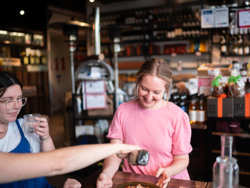 a woman smiling at a cooking class